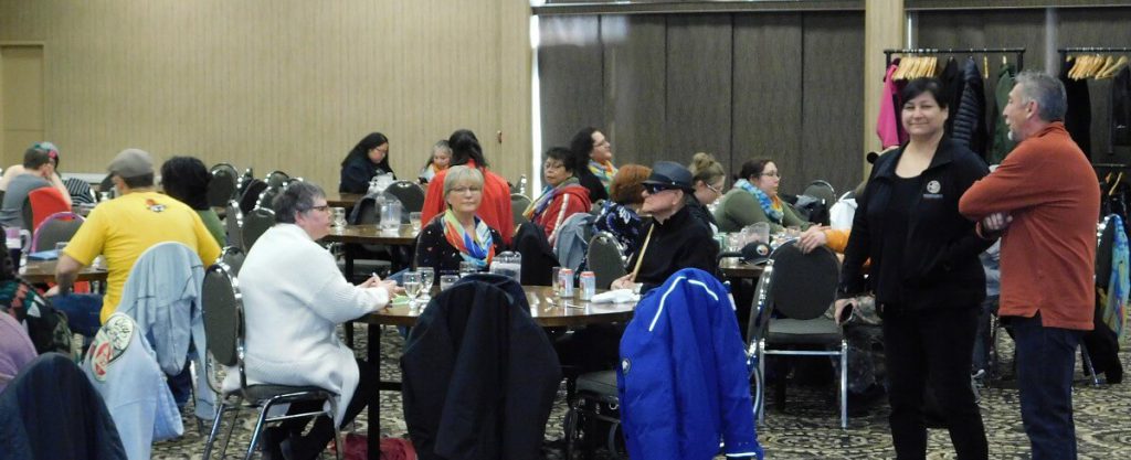 group of people sitting in large room at tables