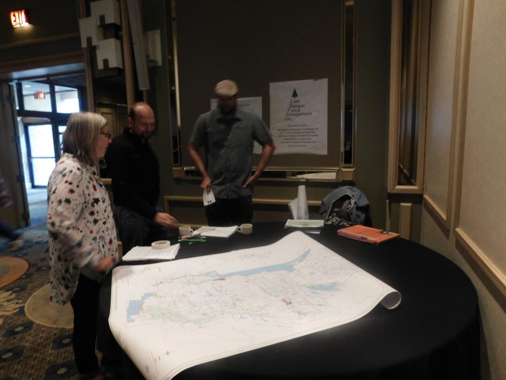Jordan and two people looking at maps on a table