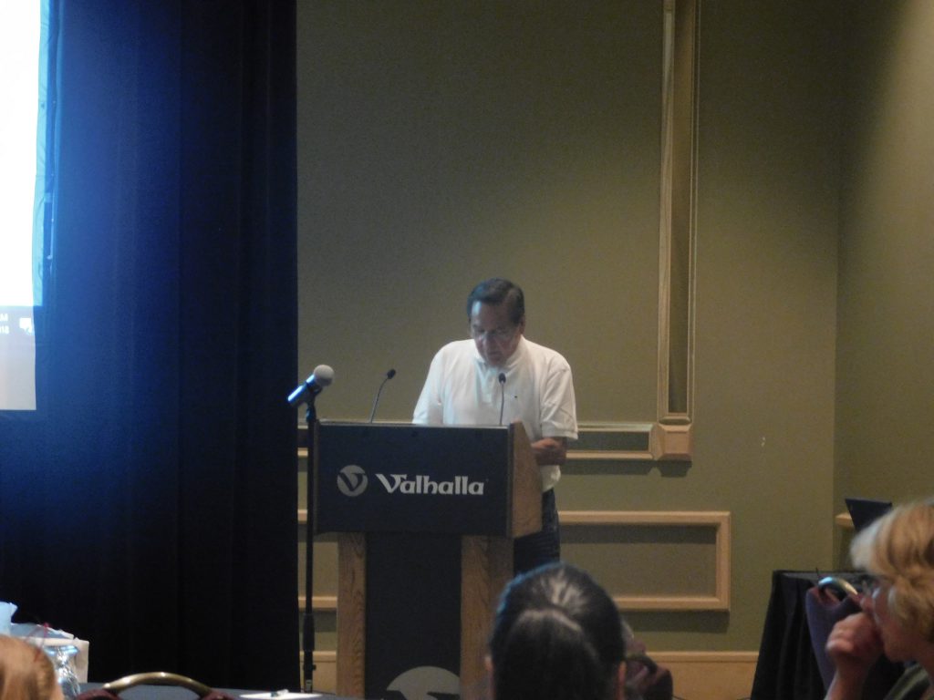 Marcel giving a speech at a podium
