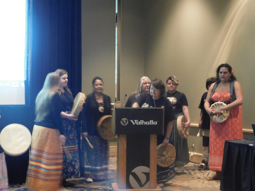 group of people on stage holding drums